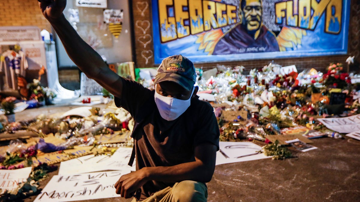Protesters gather at a memorial for George Floyd where he died outside Cup Foods on East 38th Street and Chicago Avenue, Monday, June 1, 2020, in Minneapolis. Protests continued following the death of Floyd, who died after being restrained by Minneapolis police officers on May 25. (AP Photo/John Minchillo)