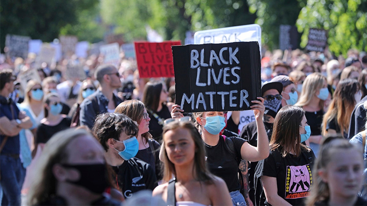 People protest under the slogan Black Lives Matter and I Can't Breathe, as they rally outside the US Embassy in Dublin, Ireland, Monday June 1, 2020, following the death of George Floyd. The recent killing of George Floyd in Minneapolis, USA, has led to protests in many countries, and across the U.S. (Niall Carson/PA via AP)