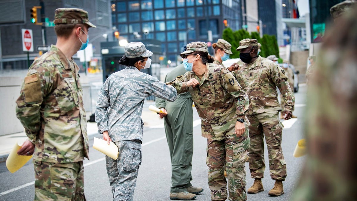 U.S Army Col. Kimberlee Aiello, commander, 44th Medical Brigade, congratulates service members during an awards ceremony prior to their departure outside the Javits Center, in New York CityThe Army announced Thursday that it will eliminate the use of photos for officer selection packets when up for promotion in an effort to halt possible racial bias. (U.S. Navy photo by Mass Communication Specialist 1st Class Kleynia R. McKnight)