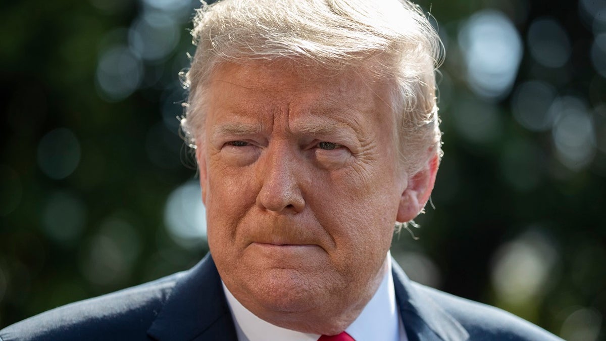 President Donald Trump speaks with reporters before departing on Marine One on the South Lawn of the White House on Tuesday.? (AP Photo/Alex Brandon)