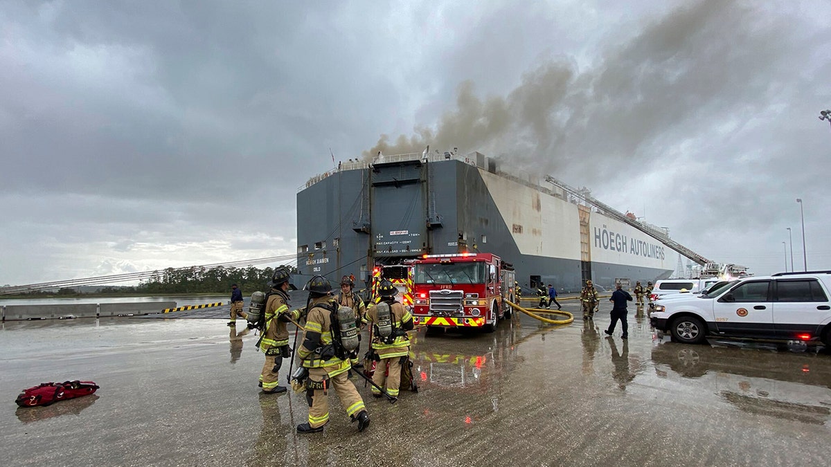 This photo provided by The Jacksonville Fire and Rescue Department shows firefighters responding to a fire after an explosion aboard a ship, June 4, in Jacksonville, Fla.  (The Jacksonville Fire and Rescue Department via AP)