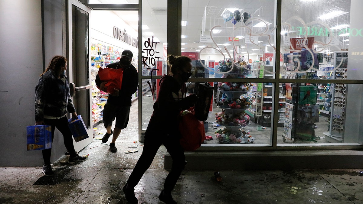 People loot a CVS store during a protest over the death of George Floyd Saturday, May 30, 2020, in Los Angeles. Floyd died in police custody Monday in Minneapolis. (AP Photo/Jae C. Hong)