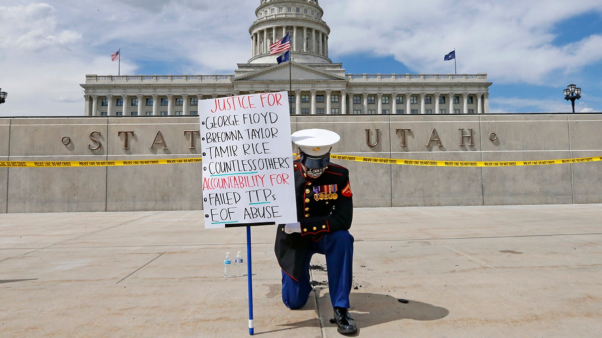 Todd Winn protesting in front of the Utah State Capitol on Friday. (AP Photo/Rick Bowmer)