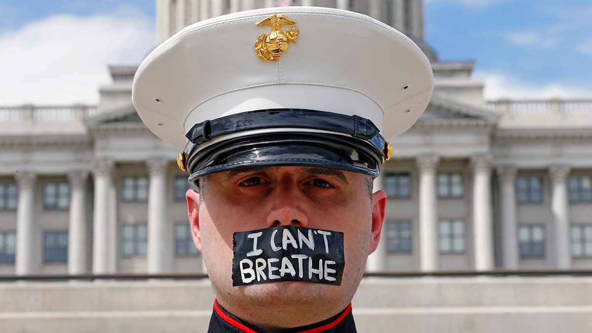 Marine vet Todd Winn, wearing a mask that read "I Can't Breathe," participating in a protest in front of the Utah State Capitol in Salt Lake City on Friday, amid protests around the world in the wake of the death of George Floyd. (AP Photo/Rick Bowmer)