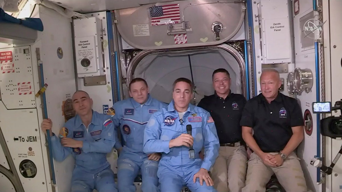 This photo provided by NASA shows Bob Behnken and Doug Hurley, far right, joining the crew at the International Space Station, after the SpaceX Dragon capsule pulled up to the station and docked Sunday, May 31, 2020. The Dragon capsule arrived Sunday morning, hours after a historic liftoff from Florida. It's the first time that a privately built and owned spacecraft has delivered a crew to the orbiting lab. (NASA via AP)