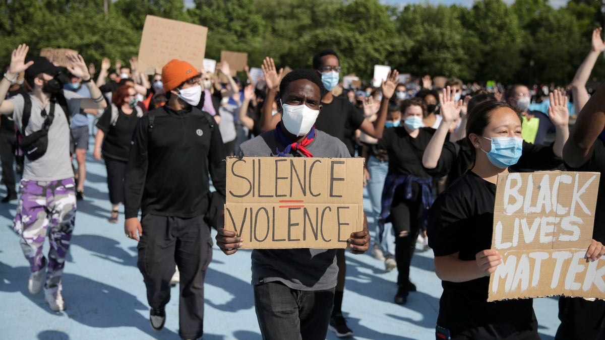 Protesters march a large sculpture of a globe in Flushing Meadows Corona Park in the Queens borough of New York, Sunday, May 31, 2020. Demonstrators took to the streets of New York City to protest the death of George Floyd, a black man who was killed in police custody in Minneapolis on May 25. (AP Photo/Seth Wenig)