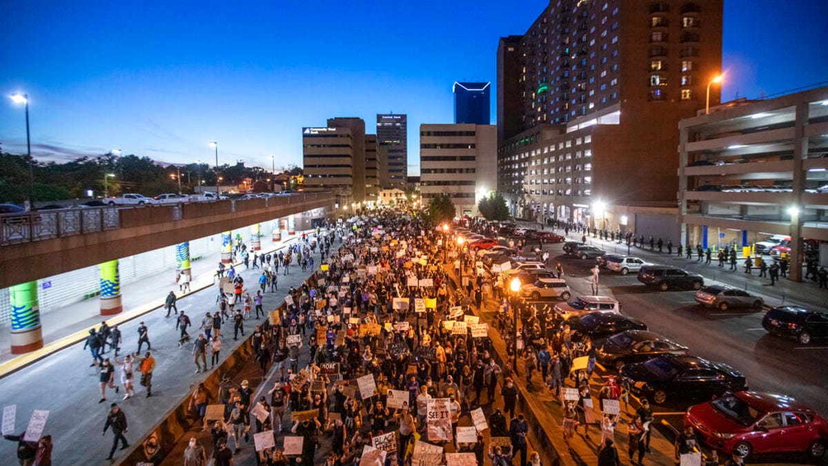 Protesters walk down East Vine Street in Lexington, Ky., during a rally against the deaths of George Floyd and Breonna Taylor on Sunday, May 31, 2020. (Ryan C. Hermens/Lexington Herald-Leader via AP)