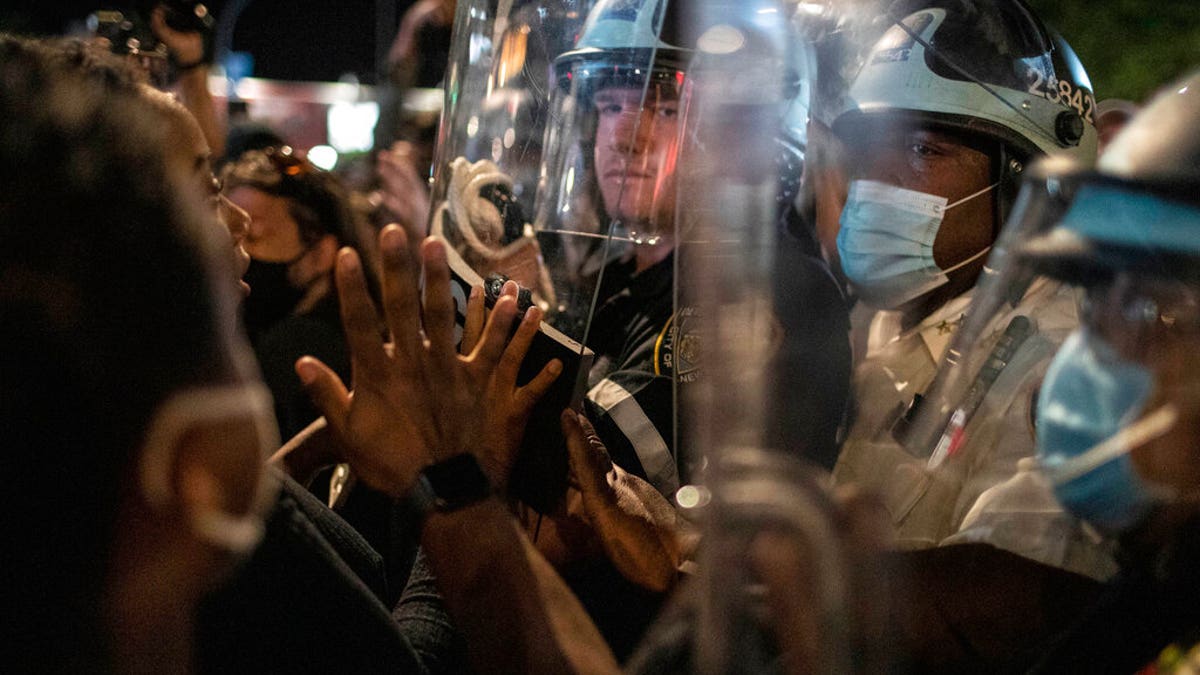 Police hold off protesters during a solidarity rally for George Floyd, Sunday, May 31, 2020, in the Brooklyn borough of New York.?