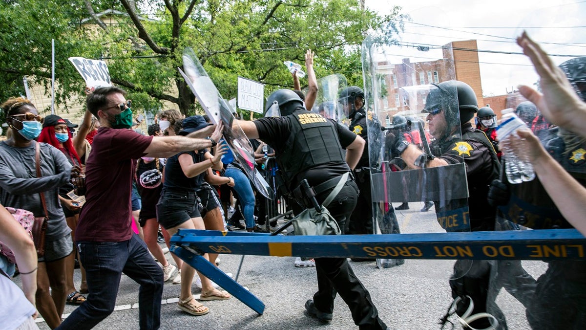 Protesters and police clash in Columbia, S.C., on Sunday. People protested against police brutality sparked by the death of George Floyd at the hands of police in Minneapolis on May 25. (Jason Lee/The Sun News via AP)