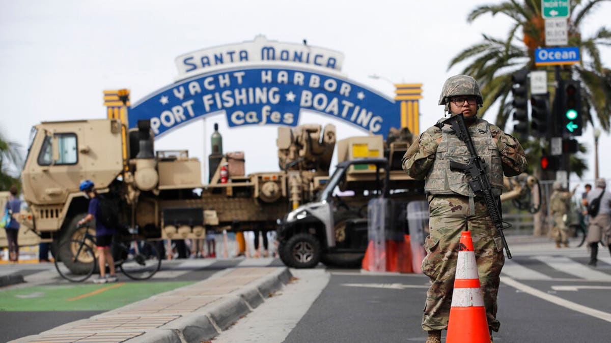 A member of the National Guard stands in front of the Santa Monica Pier building Monday, June 1, 2020, in Santa Monica, Calif.