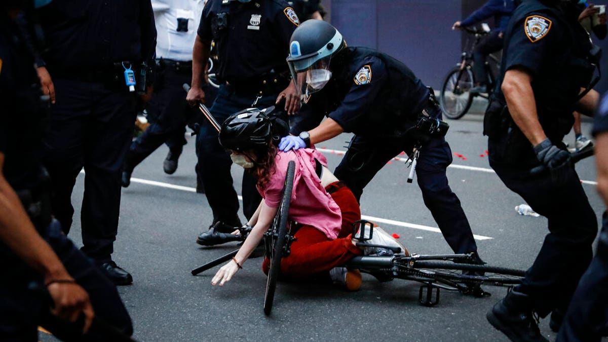 A protester is arrested by NYPD officers for violating curfew beside the iconic Plaza Hotel on 59th Street, Wednesday, June 3, 2020, in the Manhattan borough of New York. Protests continued following the death of George Floyd, who died after being restrained by Minneapolis police officers on Memorial Day. 