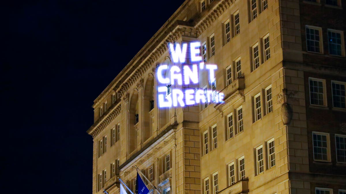 Demonstrators project the words 'we can't breathe' onto the front of the Hay Adams hotel as protests continue over the death of George Floyd, Wednesday, June 3, 2020, near the White House in Washington, D.C.