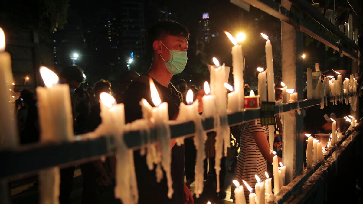 Participants light candles during a vigil for the victims of the 1989 Tiananmen Square Massacre at Victoria Park in Causeway Bay, Hong Kong, Thursday, June 4, 2020, despite applications for it being officially denied. (AP Photo/Kin Cheung)