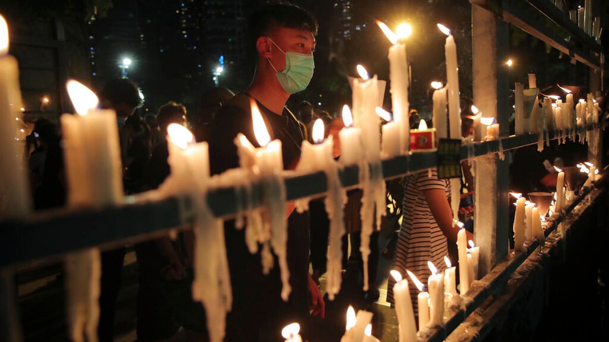 Participants light candles during a vigil for the victims of the 1989 Tiananmen Square Massacre at Victoria Park in Causeway Bay, Hong Kong, Thursday, June 4, 2020, despite applications for it being officially denied. (AP Photo/Kin Cheung)