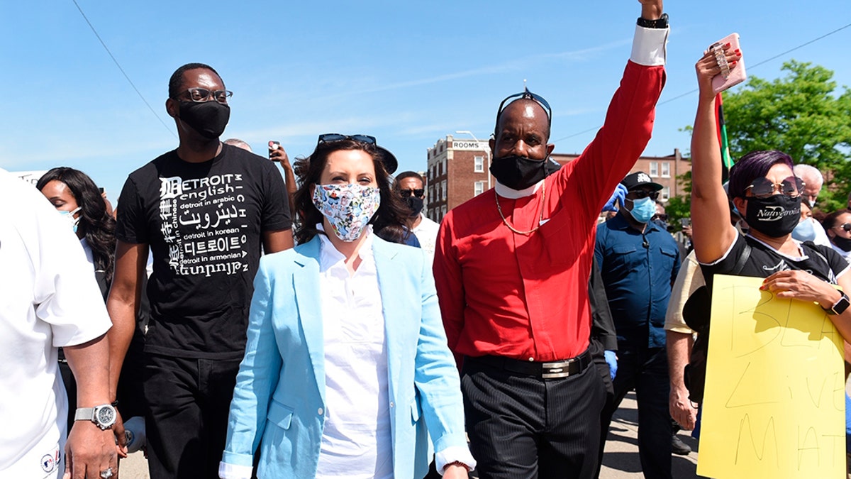 Michigan Gov. Gretchen Whitmer, center, marches with others, on Woodward during a rally in Highland Park, Thursday, June 4, 2020. (Clarence Tabb, Jr./Detroit News via AP)