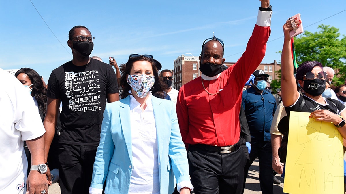 Michigan Gov. Gretchen Whitmer, center, marches with others, on Woodward during a rally in Highland Park, Thursday, June 4, 2020, in honor of George Floyd, a man who died last week while being arrested by Minneapolis police. ?(Clarence Tabb, Jr./Detroit News via AP)