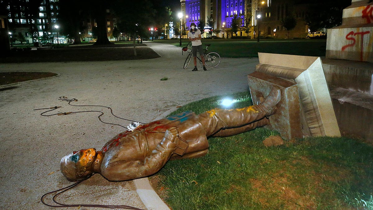 The statue of Confederate Gen. Williams Carter Wickham lies on the ground after protesters pulled it down Saturday, June 6, 2020, in Monroe Park in Richmond, Va. The statue had stood in the park since 1891. (Associated Press)