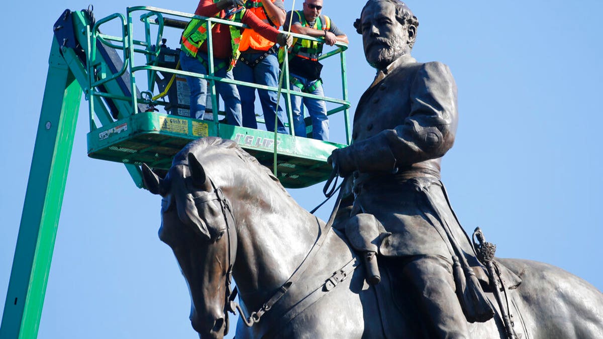 An inspection crew from the Virginia Department of General Services takes measurements as they inspect the statue of Confederate Gen. Robert E. Lee on Monument Avenue Monday June 8, 2020, in Richmond, Va. Virginia Gov. Ralph Northam has ordered the removal of the statue. (AP Photo/Steve Helber)