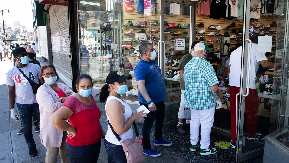 Shoppers wear masks outside a Sneaker Box store in the Bronx borough of New York City, June 8, 2020. (Associated Press)