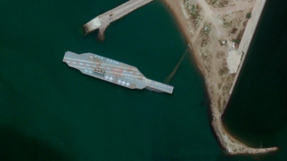 In this Sunday, June 7, 2020 satellite photo a fake aircraft carrier is seen off the coast of Bandar Abbas, Iran. 