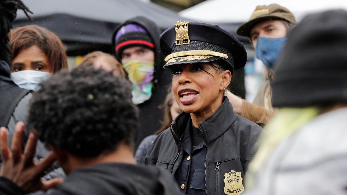 Seattle Police Chief Carmen Best talks with activists near a plywood-covered and closed Seattle police precinct Tuesday, June 9, 2020, in Seattle, following protests over the death of George Floyd, a black man who was in police custody in Minneapolis. (AP Photo/Elaine Thompson)