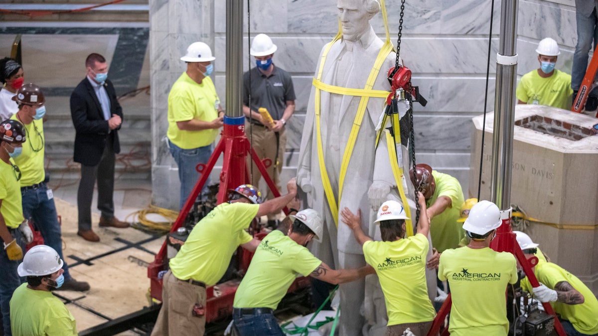 Workers prepare to remove the Jefferson Davis statue from the Kentucky state Capitol in Frankfort, Ky., on June 13. (Ryan C. Hermens/Lexington Herald-Leader via AP)
