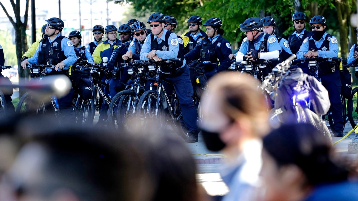 Chicago Police officers watch demonstrators on Lake Shore Drive during a protest during the Chicago March for Justice in honor of George Floyd, Saturday, June 13, 2020, in downtown Chicago. Protests in Chicago continued for the third weekend in a row Saturday following the death of George Floyd. (AP Photo/Nam Y. Huh)