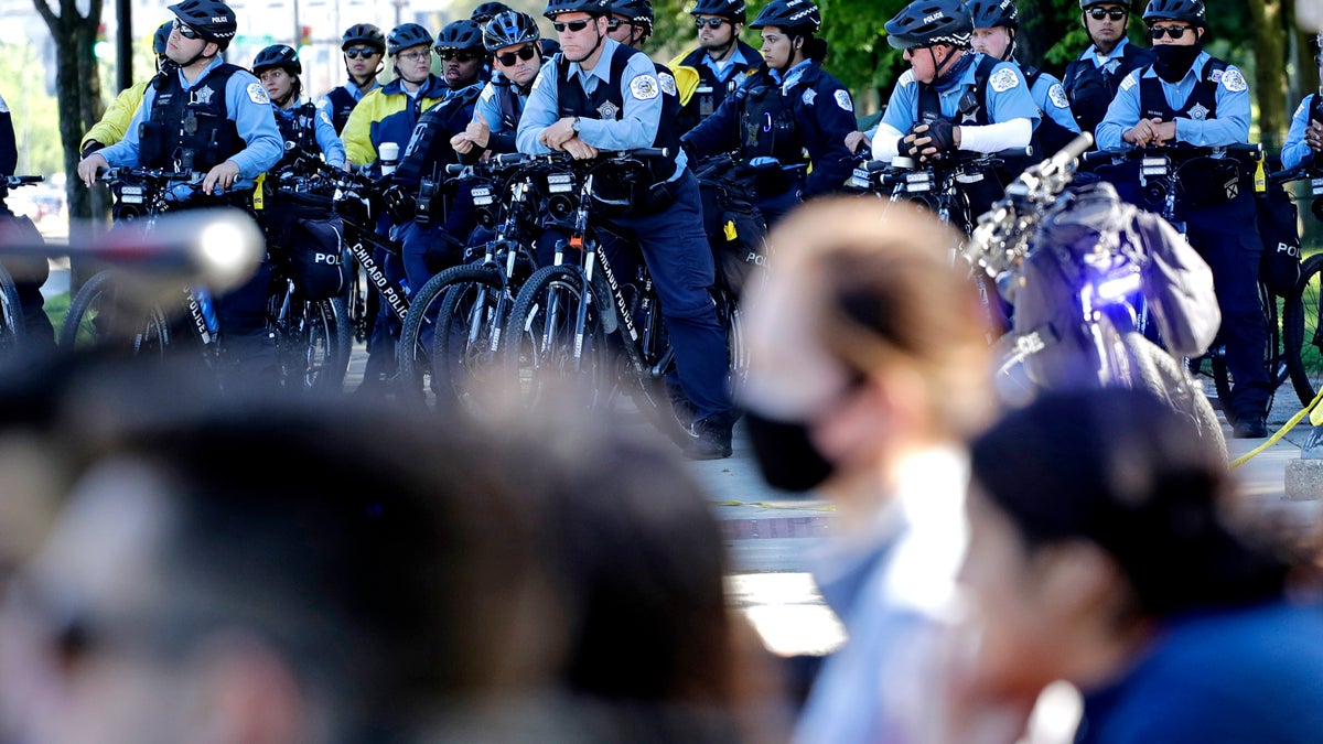 Chicago Police officers watch demonstrators on Lake Shore Drive during a protest during the Chicago March for Justice in honor of George Floyd, Saturday, June 13, 2020, in downtown Chicago. Protests in Chicago continued for the third weekend in a row Saturday following the death of George Floyd. (AP Photo/Nam Y. Huh)
