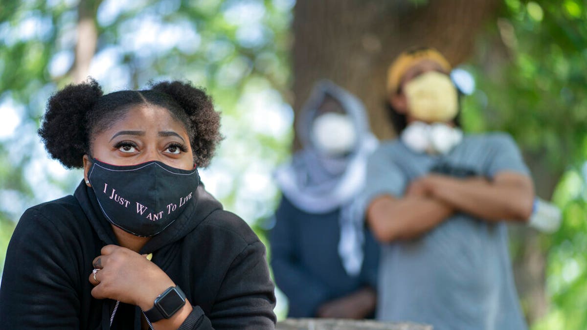 Cierra Hurst, of Brooklyn Park, Minn., and who grew up in Minneapolis, attends a gathering at North Commons Park in Minneapolis about how to address problems with the Minneapolis Police Department. 