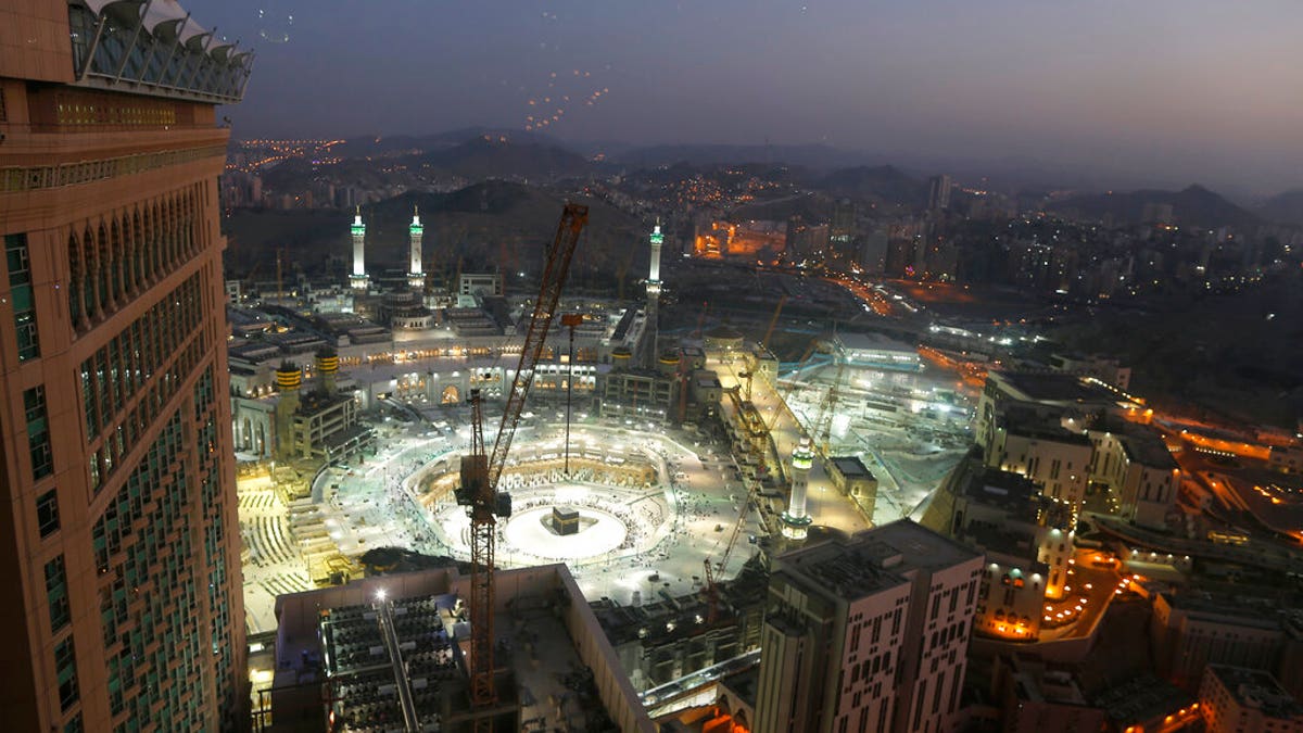 In this March 7, 2020 file photo, the sun sets at the site of the Grand Mosque, in the Muslim holy city of Mecca, Saudi Arabia, as authorities emptied Islam's holiest site for sterilization over fears of the new coronavirus. (AP Photo/Amr Nabil, File)