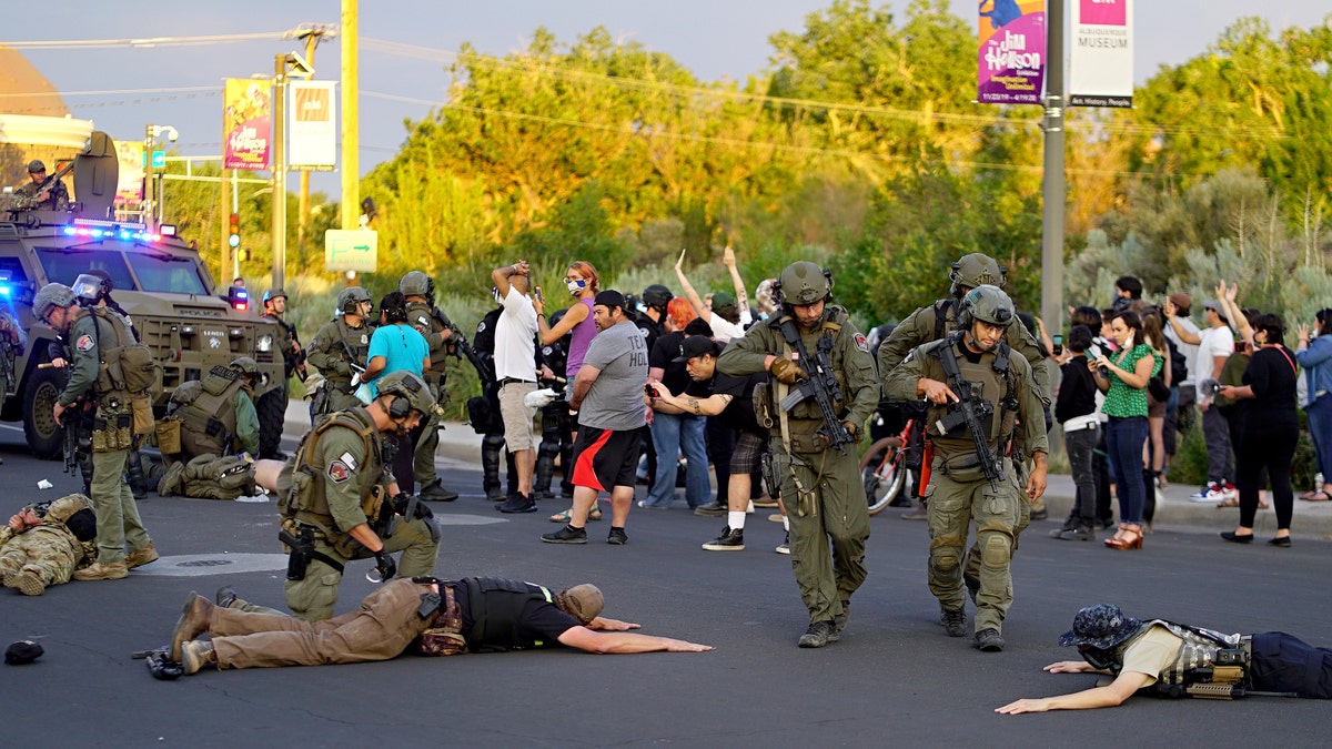 Albuquerque police detain members of the New Mexico Civil Guard, an armed civilian group, Monday, June 15, 2020, in Albuquerque, N.M. (Adolphe Pierre-Louis/The Albuquerque Journal via AP)