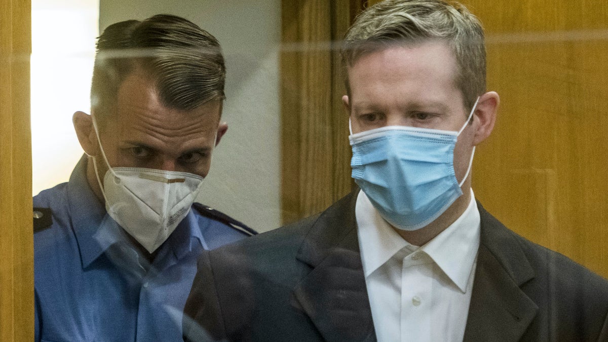 Defendant Stephan Ernst, right, who is accused of murdering politician Walter Luebcke, arrives for the first day of his trial at the Oberlandgericht Frankfurt courthouse, in Frankfurt, Germany, Tuesday, June 16, 2020. (Thomas Lohnes/Pool via AP)