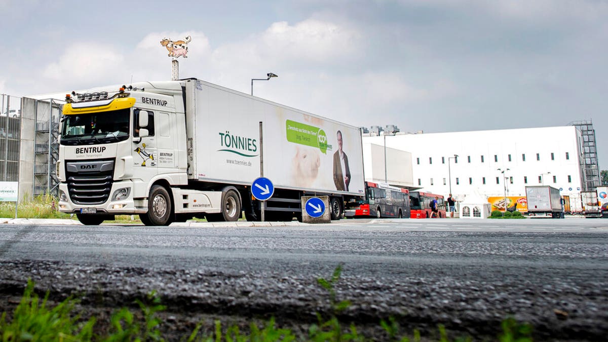 A truck leaves the Toennies meatpacking plant in Rheda-Wiedenbrueck, Germany, where more than 650 new cases of COVID-19 have been recorded among workers at a large meatpacking plant.