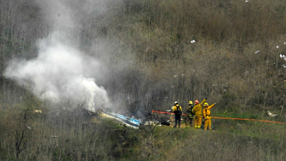 <br>
Firefighters work the scene of a helicopter crash where former NBA star Kobe Bryant died in Calabasas, Calif., Jan. 26, 2020. (Associated Press)