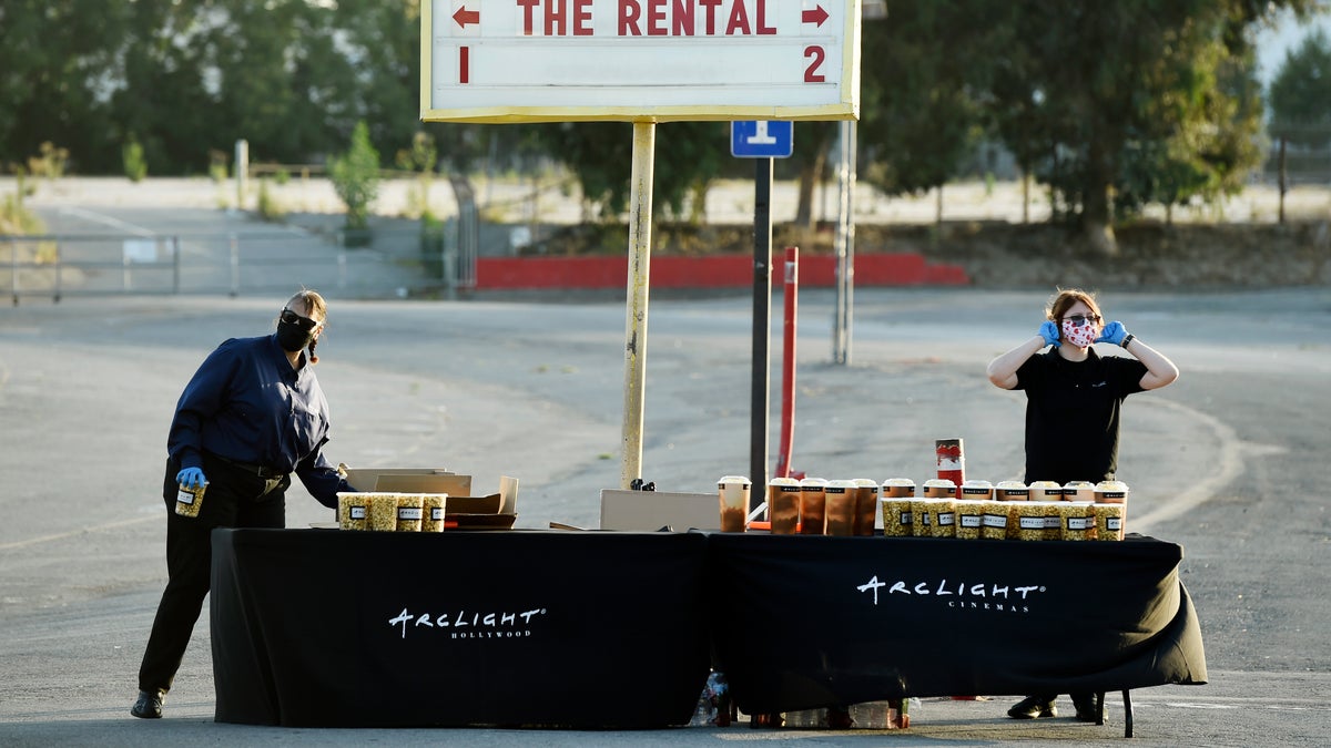 Workers prepare to hand out concessions to drivers before an advance screening of the film "The Rental" at Vineland Drive-In, Thursday, June 18, 2020, in City of Industry, Calif. (AP Photo/Chris Pizzello)
