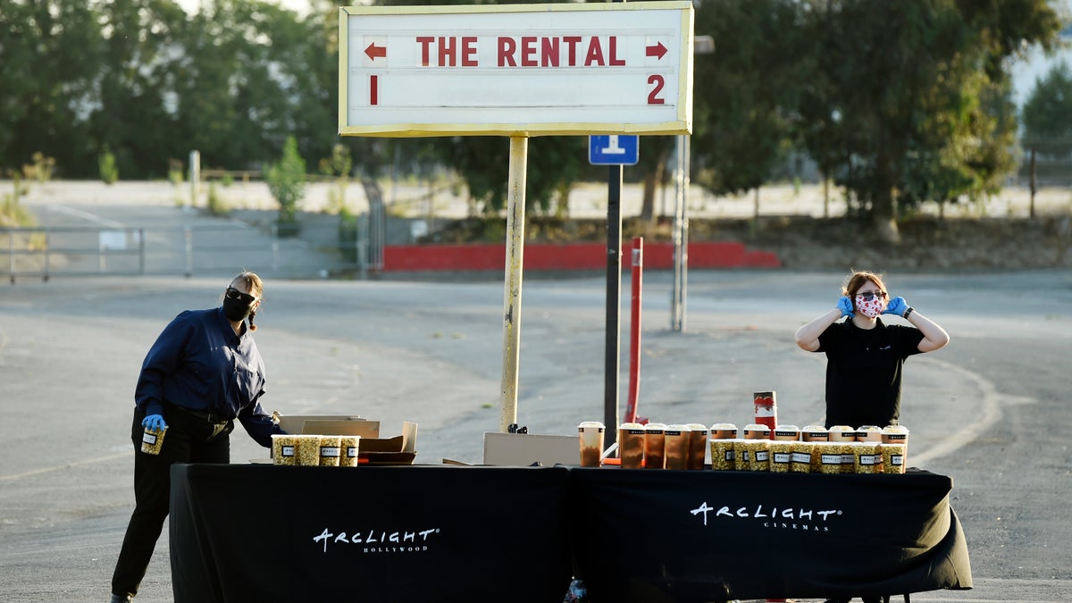 Workers prepare to hand out concessions to drivers before an advance screening of the film "The Rental" at Vineland Drive-In, Thursday, June 18, 2020, in City of Industry, Calif. (AP Photo/Chris Pizzello)