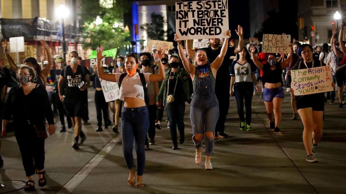 Demonstrators march near the BOK Center where President Trump is holding a campaign rally in Tulsa, Okla., Saturday, June 20, 2020. (AP Photo/Charlie Riedel)