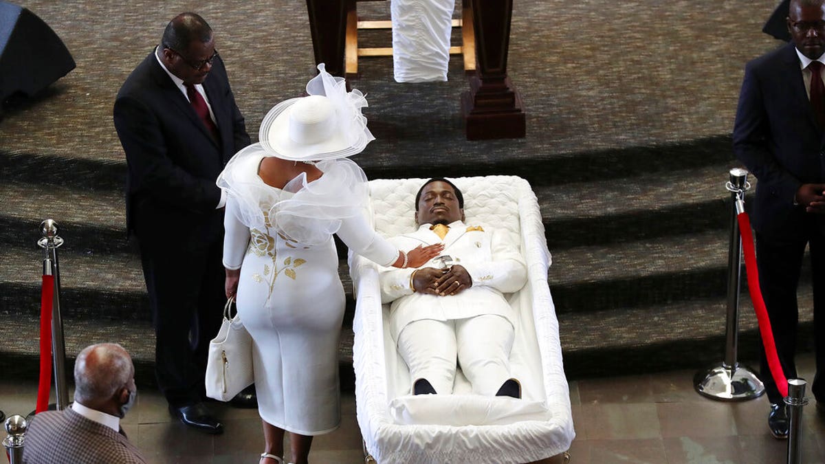 Tomika Miller, the wife of Rayshard Brooks, touches her husband during a family visit just before a public viewing begins at Ebenezer Baptist Church on Monday, Jun 22, 2020 in Atlanta.?