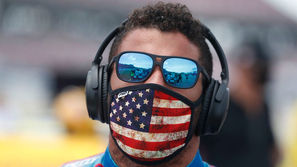 Driver Bubba Wallace walks to his car in the pits of the Talladega Superspeedway prior to the start of the NASCAR Cup Series auto race at the Talladega Superspeedway in Talladega Ala. (AP Photo/John Bazemore)