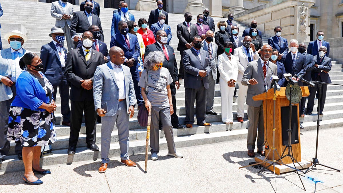 Lawmakers and members of the Mississippi Legislative Black Caucus call on the Legislature to vote for a new flag this session, during a news conference in front of the Capitol in Jackson, Miss.