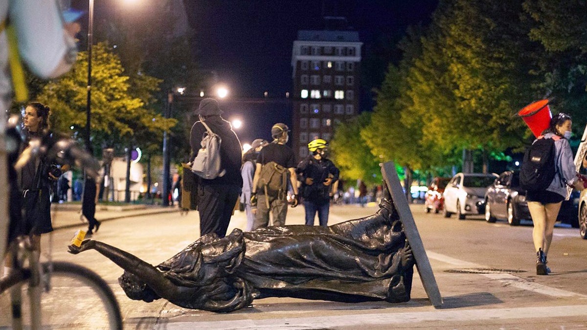 Wisconsin's "Forward" statue lies in the street on Capitol Square in Madison on Tuesday. The statue has since been recovered, officials said. (Emily Hamer/Wisconsin State Journal via AP)