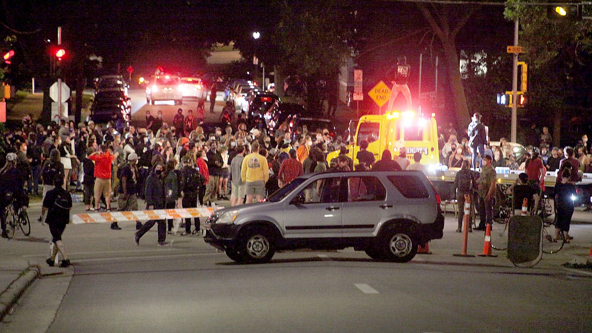 Protesters block traffic at an intersection an intersection near Capitol Square in Madison, Wis. Tuesday, June 23, 2020. (Emily Hamer/Wisconsin State Journal via AP)