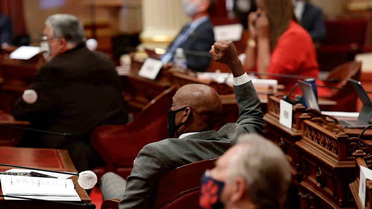 California state Sen. Steven Bradford, D-Gardena, center, raises his fist in celebration after lawmakers agree to place a proposed Constitutional amendment on the November ballot to overturn the state's ban on affirmative action programs, at the Capitol, in Sacramento, June 24, 2020. (Associated Press)