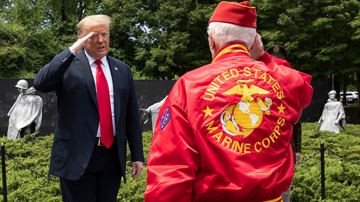 President Donald Trump salutes a veteran after placing a wreath at the Korean War Veterans Memorial, Thursday, June 25, 2020, in Washington. (AP Photo/Alex Brandon)