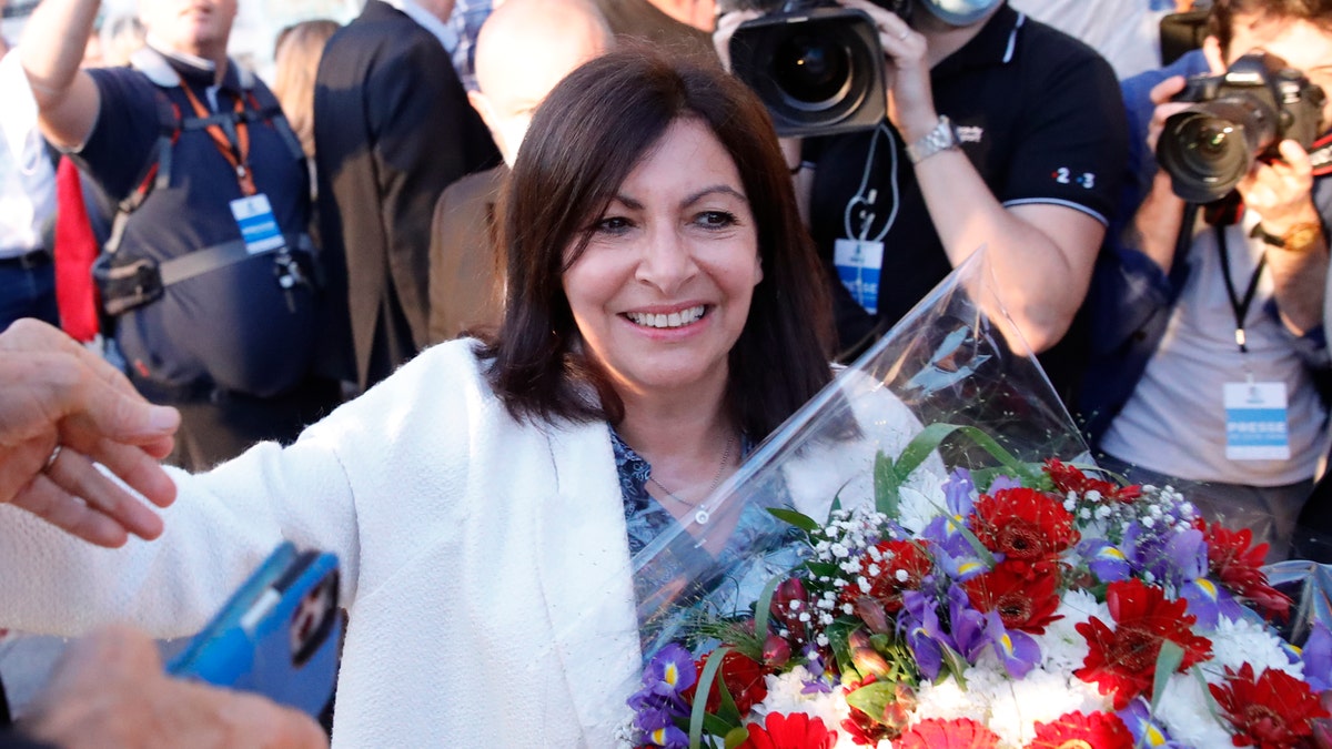 Paris Mayor Anne Hidalgo getting a bouquet of flowers after her victorious second round of the municipal election Sunday.