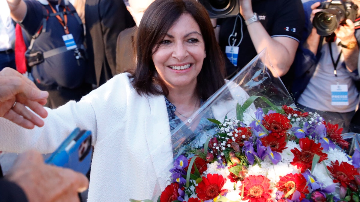 Paris Mayor Anne Hidalgo getting a bouquet of flowers after her victorious second round of the municipal election Sunday.