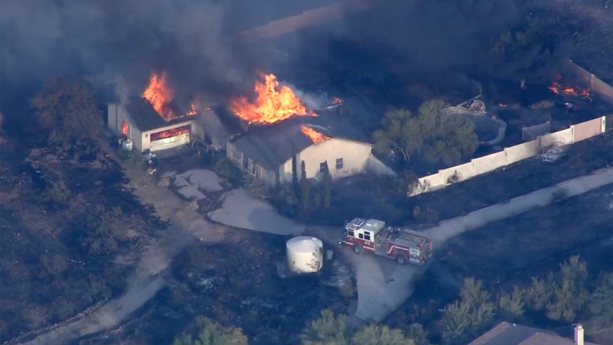 A home burns as the Aquila Fire rapidly spread through a north Phoenix neighborhood on Tuesday.