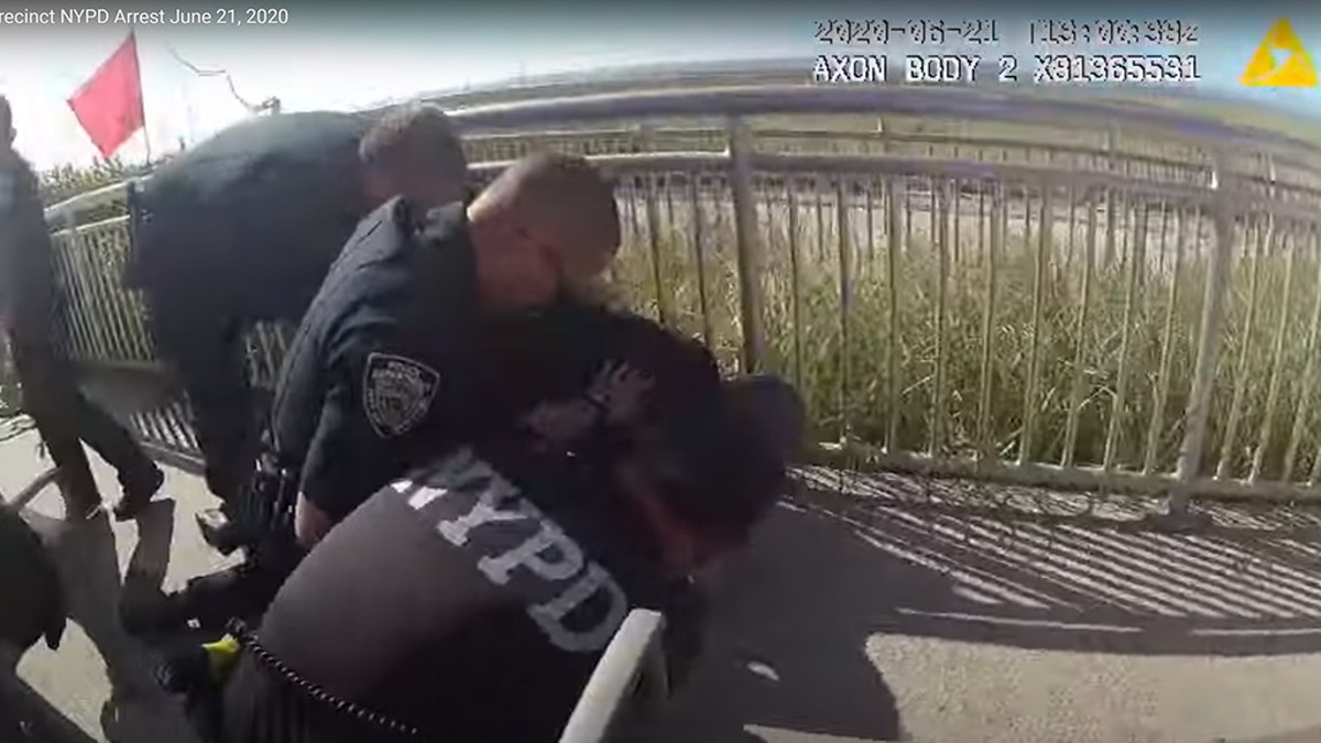 One of the officers in the video was seen with his arm wrapped around the suspect’s neck.