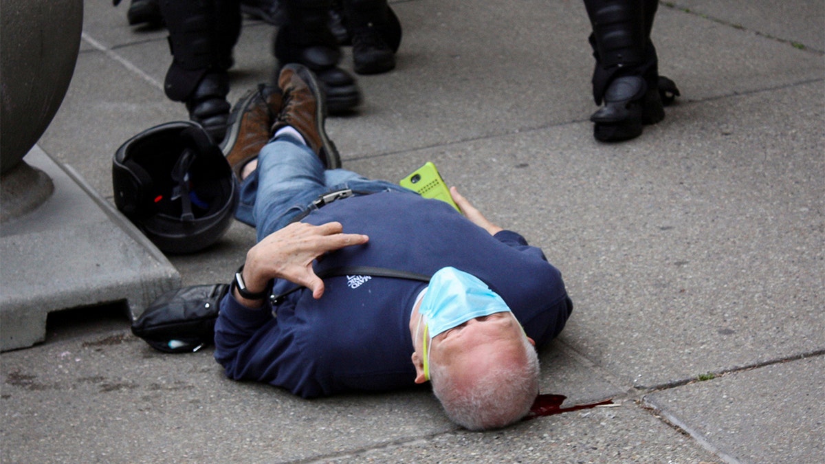 Martin Gugino, a 75-year-old protester, lays on the ground after he was shoved by two Buffalo, New York, police officers