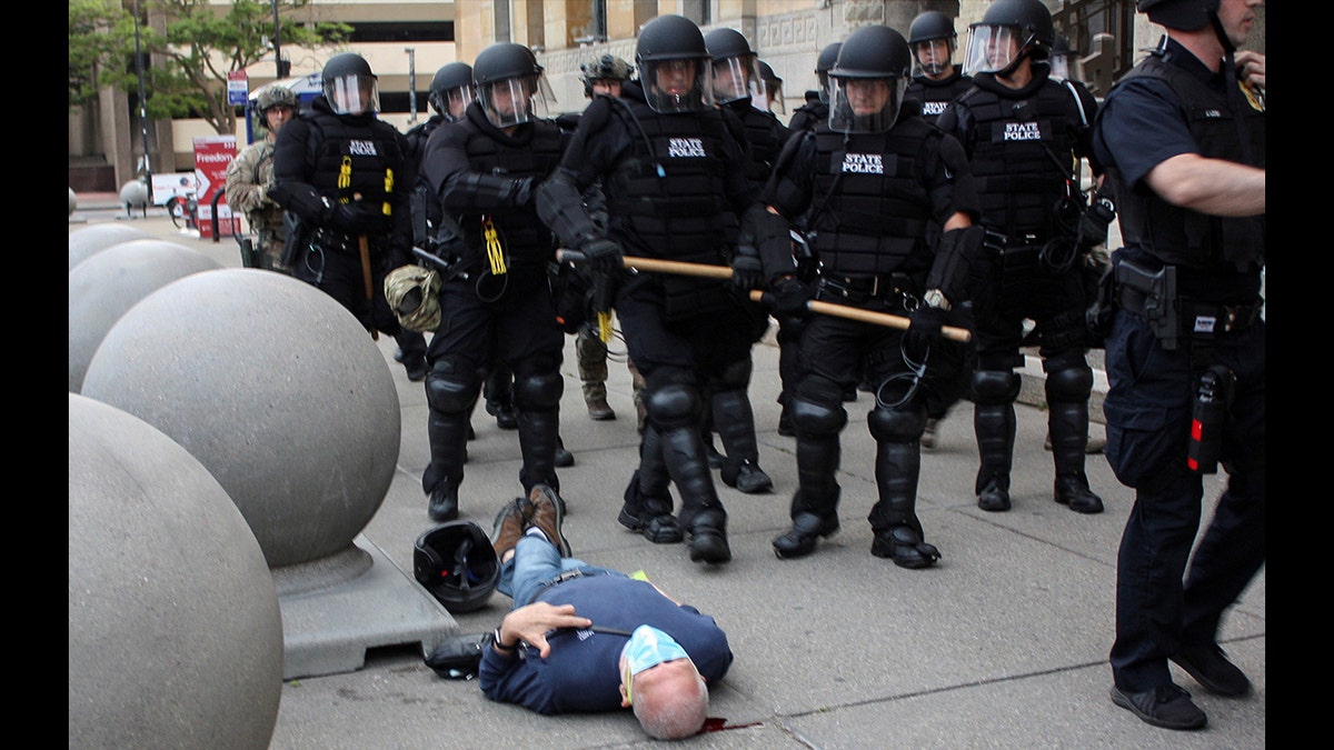 Martin Gugino, a 75-year-old protester, lays on the ground after he was shoved by two Buffalo, New York, police officers during a protest against the death in Minneapolis police custody of George Floyd in Niagara Square in Buffalo, New York, U.S., June 4, 2020. Picture taken June 4, 2020.